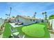 Spacious backyard features a putting green, patio area, and lush landscaping at 7524 N Via Del Elemental --, Scottsdale, AZ 85258