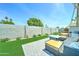 Cozy backyard with artificial turf, patio seating, and a built-in fire pit for relaxing at 7524 N Via Del Elemental --, Scottsdale, AZ 85258