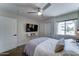 Comfortable bedroom with a mounted TV, large window, carpet floors, and closet at 7524 N Via Del Elemental --, Scottsdale, AZ 85258