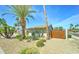Well-maintained home featuring desert landscaping, palm trees, and a wooden gate at 7524 N Via Del Elemental --, Scottsdale, AZ 85258