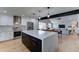 Open-concept kitchen with stainless steel appliances, a large island, and a view into the living and dining areas at 7524 N Via Del Elemental --, Scottsdale, AZ 85258
