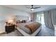 Well-lit main bedroom featuring a tufted headboard, nightstands, and slider to backyard at 7524 N Via Del Elemental --, Scottsdale, AZ 85258