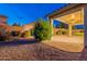 Backyard with a covered patio and low maintenance desert landscaping at 7606 E Globemallow Ln, Gold Canyon, AZ 85118
