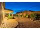 An outdoor area with brick pavers transitions into gravel, beautifully landscaped with desert plants and views at 7606 E Globemallow Ln, Gold Canyon, AZ 85118