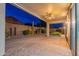 Backyard with a covered patio, desert landscaping, and privacy wall at 7606 E Globemallow Ln, Gold Canyon, AZ 85118