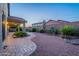 Beautiful backyard featuring a patio with desert landscaping, brick pavers, and privacy fence at 7606 E Globemallow Ln, Gold Canyon, AZ 85118