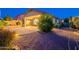 The backyard features an expansive covered patio with pavers and desert-friendly landscaping at 7606 E Globemallow Ln, Gold Canyon, AZ 85118