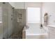 Bright bathroom features a glass shower and soaking tub with tile flooring at 7606 E Globemallow Ln, Gold Canyon, AZ 85118