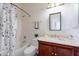 Well-lit bathroom featuring a shower over tub and a vanity with a wood cabinet at 7606 E Globemallow Ln, Gold Canyon, AZ 85118
