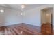 Large and well-lit bedroom with dark wood floors, a ceiling fan, and an arched doorway at 7606 E Globemallow Ln, Gold Canyon, AZ 85118