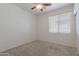 Bedroom featuring a ceiling fan, window, and carpeted flooring at 7606 E Globemallow Ln, Gold Canyon, AZ 85118