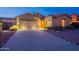 Charming single-story home with a well-lit driveway and attached three-car garage at 7606 E Globemallow Ln, Gold Canyon, AZ 85118