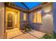 Inviting front entrance with a security door, stylish lighting, and desert landscaping at 7606 E Globemallow Ln, Gold Canyon, AZ 85118