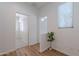 Bright hallway features hardwood floors and a plant at 7606 E Globemallow Ln, Gold Canyon, AZ 85118