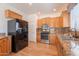Bright kitchen with stainless steel appliances, ample storage, and sleek black refrigerator at 7606 E Globemallow Ln, Gold Canyon, AZ 85118