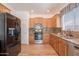 Well-lit kitchen featuring modern appliances, granite countertops, and stylish backsplash at 7606 E Globemallow Ln, Gold Canyon, AZ 85118