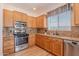 The kitchen is complete with stainless steel appliances, wood cabinets, and granite countertops at 7606 E Globemallow Ln, Gold Canyon, AZ 85118
