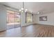Open-plan living space with wood floors, a chandelier, and sliding glass doors to an outdoor patio at 7606 E Globemallow Ln, Gold Canyon, AZ 85118