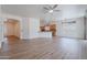 Spacious open-plan living room with wood floors, a ceiling fan, and access to the dining and kitchen areas at 7606 E Globemallow Ln, Gold Canyon, AZ 85118