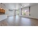 Bright and airy living room featuring wood floors, a ceiling fan, and large windows with a view to the exterior at 7606 E Globemallow Ln, Gold Canyon, AZ 85118