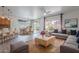 Bright and airy living space with stylish furniture and seamless flow to the kitchen and dining areas at 7606 E Globemallow Ln, Gold Canyon, AZ 85118