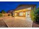 Covered patio boasts brick pavers and recessed lighting, accessible via sliding glass door from the home's interior at 7606 E Globemallow Ln, Gold Canyon, AZ 85118