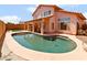 Enjoy a backyard with a sparkling pool, covered patio, and lush artificial turf at 7767 W Sierra Vista Dr, Glendale, AZ 85303