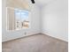 Bedroom featuring neutral carpet and a large window bringing in light and a view at 7767 W Sierra Vista Dr, Glendale, AZ 85303