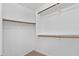 Walk-in closet with custom wood shelving and carpeted flooring for ample storage at 7767 W Sierra Vista Dr, Glendale, AZ 85303