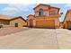 Two-story house with an earthy color palette, a two-car garage, desert landscaping, and an arched entryway at 7767 W Sierra Vista Dr, Glendale, AZ 85303