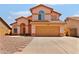 Two-story home featuring a tile roof, two-car garage, and desert landscaping at 7767 W Sierra Vista Dr, Glendale, AZ 85303