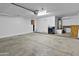 Spacious garage features laundry area, water heater, and storage cabinets, providing ample space for vehicles and storage at 7767 W Sierra Vista Dr, Glendale, AZ 85303