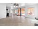 Bright living area offering tile flooring, access to pool area, and modern design at 7767 W Sierra Vista Dr, Glendale, AZ 85303