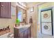 Bathroom vanity and mirror with a doorway to a stacked washer and dryer at 8111 W Wacker Rd # 62, Peoria, AZ 85381