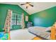 Vaulted bedroom with green walls, hardwood floors, and a large window at 8111 W Wacker Rd # 62, Peoria, AZ 85381