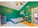 Bedroom with green walls, hardwood floors, and modern ceiling fan fixture at 8111 W Wacker Rd # 62, Peoria, AZ 85381