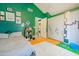 Bedroom with green walls, hardwood floors, and a laundry room entrance at 8111 W Wacker Rd # 62, Peoria, AZ 85381