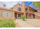 Charming townhome featuring a brick chimney, colorful landscaping, and a cozy, inviting entrance at 8111 W Wacker Rd # 62, Peoria, AZ 85381