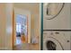Hallway with a stacked washer and dryer and an open doorway to a bedroom at 8111 W Wacker Rd # 62, Peoria, AZ 85381