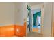 Hallway with wood paneling and stacked washer and dryer near an open bedroom doorway at 8111 W Wacker Rd # 62, Peoria, AZ 85381