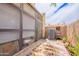 Cozy enclosed patio featuring an AC unit, a ladder and an outdoor rug on concrete at 8111 W Wacker Rd # 62, Peoria, AZ 85381