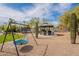 Spacious backyard featuring a swing set, trampoline, and outdoor seating area with a gazebo at 8502 E Santa Catalina Dr, Scottsdale, AZ 85255