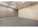 A blank canvas room with epoxy floors, ample lighting, and neutral walls at 8502 E Santa Catalina Dr, Scottsdale, AZ 85255