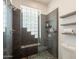 Stylish bathroom with a modern shower featuring glass block window and pebble floor at 8502 E Santa Catalina Dr, Scottsdale, AZ 85255