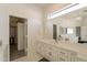 Bright bathroom with long countertop, vanity, and a large walk-in closet at 8502 E Santa Catalina Dr, Scottsdale, AZ 85255