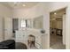 Elegant bathroom featuring dual sinks, vanity area, and a spacious walk-in closet for ample storage at 8502 E Santa Catalina Dr, Scottsdale, AZ 85255