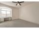 A cozy bedroom boasts natural light from a large window and a built-in desk with drawers at 8502 E Santa Catalina Dr, Scottsdale, AZ 85255