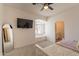 Bright bedroom featuring arched window with built-in seating and TV at 8502 E Santa Catalina Dr, Scottsdale, AZ 85255