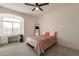 Bright bedroom with arched window featuring desk and dresser area at 8502 E Santa Catalina Dr, Scottsdale, AZ 85255
