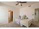 Cozy bedroom with neutral tones and an adjoining bathroom with an arched entryway at 8502 E Santa Catalina Dr, Scottsdale, AZ 85255